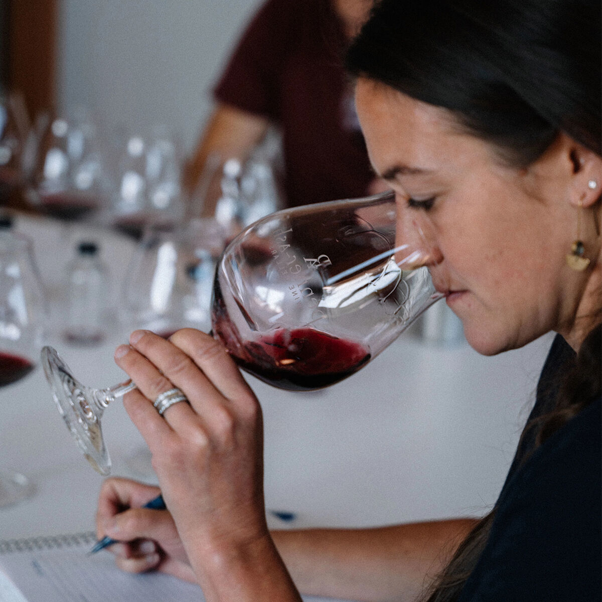 Penner-Ash winemaker tasting wine.